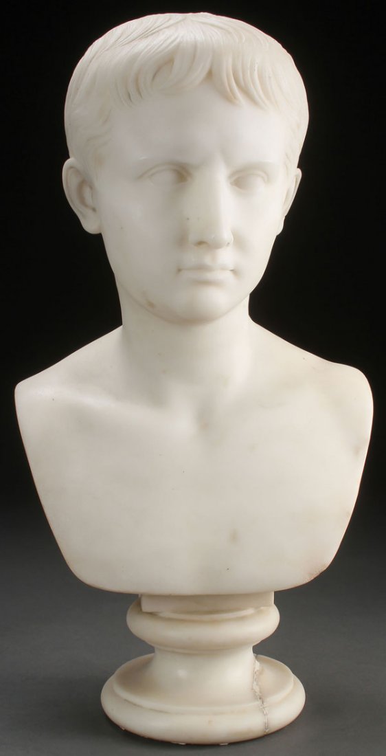 A CARVED WHITE MARBLE BUST, YOUNG JULIUS CAESAR: A CARVED WHITE MARBLE BUST OF THE YOUNG JULIUS CAESAR, ROMAN, 19TH CENTURY. Finely carved with good detailing and set into a socle plinth. Height 19.75 inches (50 cm). SHIPPING NOTICE: Jackson’s is
