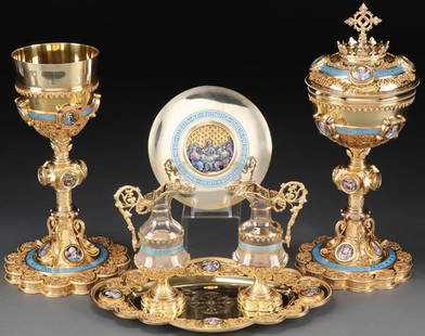 EXCEPTIONAL FRENCH SILVER & ENAMEL COMMUNION SET 1912: AN EXQUISITE SILVER GILT AND ENAMELED GOTHIC STYLE CHALICE, CIBORIUM AND CRUET SET, FRENCH, CIRCA 1912. Comprising a fully matched set including a chalice with multiple lobed base mounted with filigr