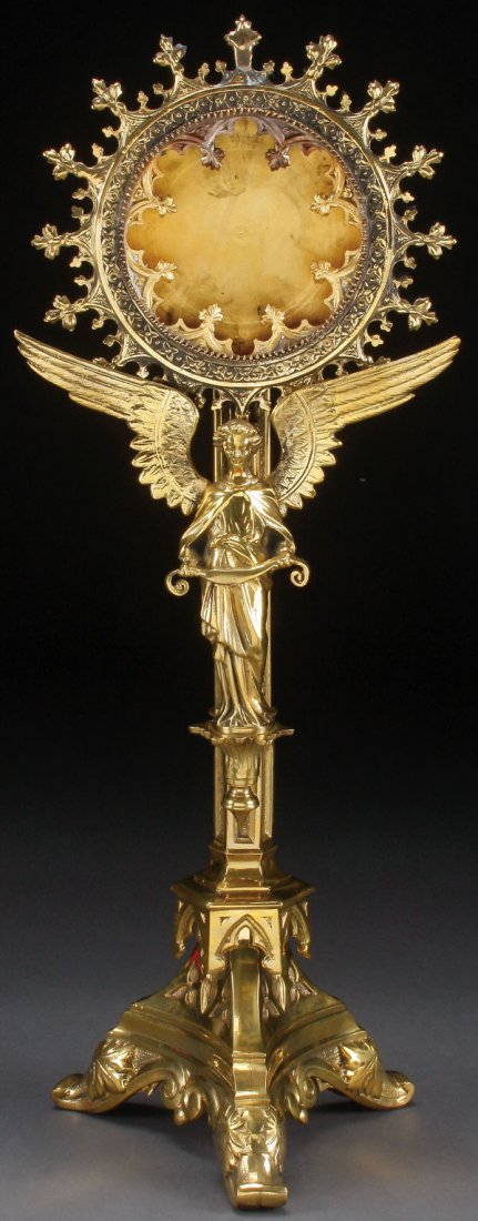 ANGEL GILT BRONZE NEO GOTHIC RELIQUARY, 19TH C.: A GILT BRONZE FIGURAL GOTHIC STYLE RELIQUARY, FRENCH, 19TH CENTURY. Resting on a trefoil base with scroll feet and apron, above which sets an overhanging Gothic cap from which rises a fluted hexagonal