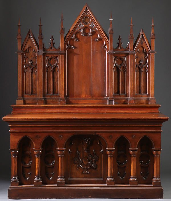 LARGE CARVED OAK NEO GOTHIC ALTAR CIRCA 1900: AN ATTRACTIVE CARVED OAK NEO GOTHIC ALTAR, CIRCA 1900. The large rectangular base with deep central arched reserve displaying a carved relief chalice together with wheat and grapes, the central reserv
