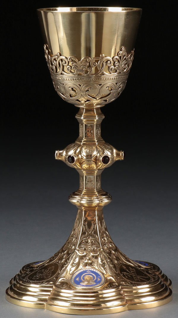 A GILDED STERLING SILVER AND ENAMEL CHALICE: A GILDED STERLING SILVER AND ENAMEL CHALICE, 19TH CENTURY. The stepped six lobed base set with three enameled medallions depicting Christ, the Virgin Mary and St. Joseph, together with three other res