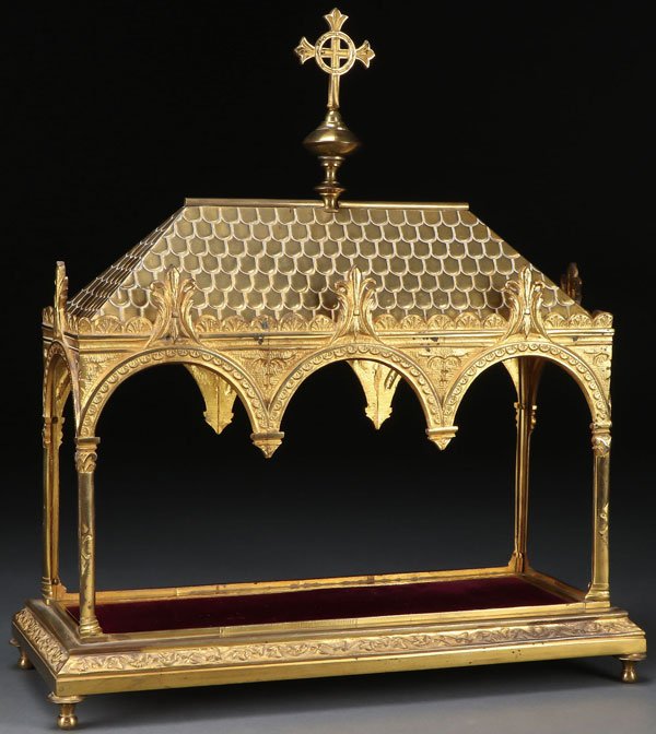 A GILT BRONZE GOTHIC STYLE RELIQUARY: A LARGE AND IMPRESSIVE GILT BRONZE GOTHIC STYLE RELIQUARY, FRENCH, 19TH CENTURY. Configured as Gothic style cathedral, resting on four raised feet, the sides opened with three overhanging arches, the 