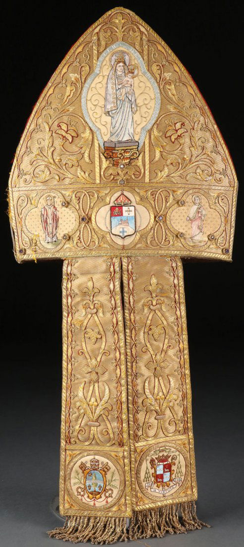 PAPAL BASILICA BROCADE BISHOP'S MITRE: AN IMPRESSIVE PAPAL BASILICA BROCADE BISHOP'S MITRE, PROBABLY FRENCH, CIRCA 1900. Of traditional peaked form, the front heavily embroidered in bullion thread and within a quatrefoil cartouche, at top