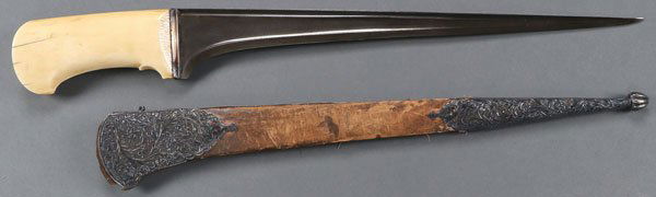 A PESH-KABZ OR KARUD, PROBABLY NORTHERN INDIA: A PESH-KABZ OR KARUD, PROBABLY NORTHERN INDIA, 19TH CENTURY. Distinctive straight, reinforced single-edged fine Damascus blade with T-shaped back and single piece carved, and polished walrus ivory hi