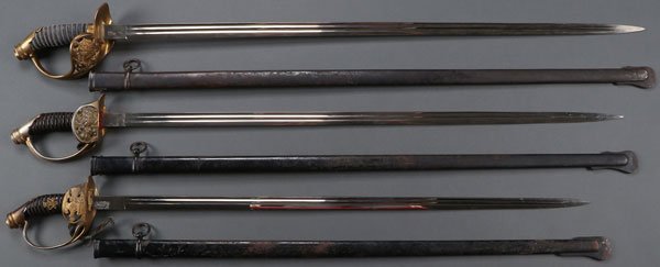 A GROUP OF THREE GERMAN PRUSSIAN SWORDS: A GROUP OF THREE GERMAN PRUSSIAN SWORDS. Comprising three model 1899 officers swords including one with guard displaying the Prussian eagle and two with the Wurttemburg crest. Each with double fuller,