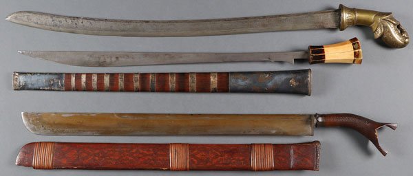 A GROUP OF THREE ASIAN EDGED WEAPONS, INDONESIA: A GROUP OF THREE ASIAN EDGED WEAPONS, INDONESIA, MALAYSIA AND PILIPPINO, 19TH/20TH CENTURY. Comprising a golok style sword with straight single edged damascus blade and single fuller beneath reinforce