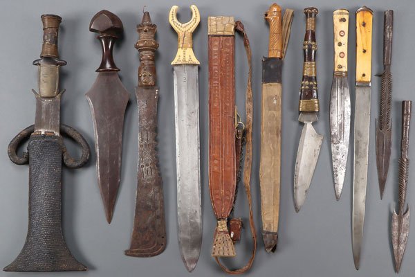A GOOD GROUP OF 10 VINTAGE AFRICAN EDGED WEAPONS: A GOOD GROUP OF 10 VINTAGE AFRICAN EDGED WEAPONS, 19TH CENTURY. Comprising a good Mbole knife with asymmetrical blade, hardwood grip with heavy iron pommel, length 17 inches (43 cm), a large short swo