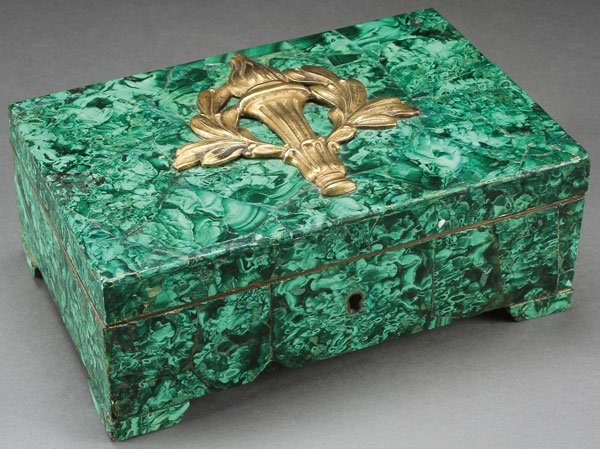 AN ORMOLU MOUNTED VENEERED MALACHITE BOX, FRENCH: AN ORMOLU MOUNTED VENEERED MALACHITE BOX, FRENCH, 19TH CENTURY. The wood carcass veneered with malachite and each corner with raised foot, and the hinged lid with bronze torch. Width 9 inches (23 cm),