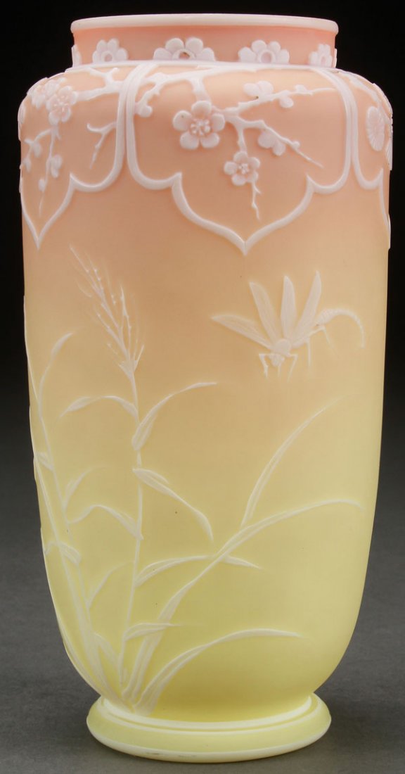 THOMAS WEBB AND SONS ENGLISH CAMEO VASE: A FINE THOMAS WEBB AND SONS ENGLISH CAMEO ART GLASS VASE, LATE 19TH CENTURY. Of tapering cylindrical form in Burmese glass overlaid with white, and cut with a design of tall grasses with dragonfly an