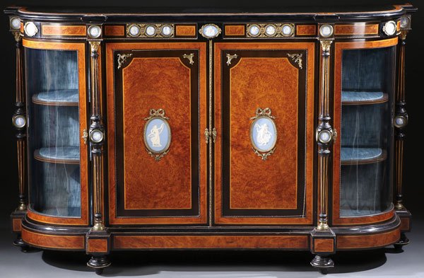 A FINE ENGLISH EBONIZED AND BURRWOOD SIDE CABINET: A FINE ENGLISH EBONIZED AND BURRWOOD SIDE CABINET, CIRCA 1870. Of elongated demilune form with two door fronts finished in intricate wood burro and mounted with Neo classic jasperwear plaques in gilt 
