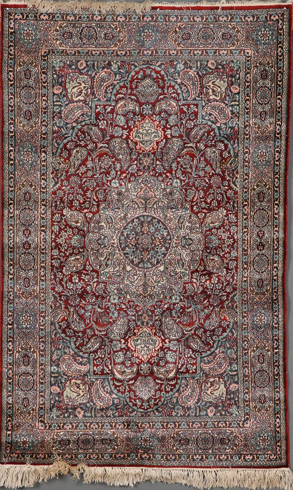 A PERSIAN STYLE HAND WOVEN ORIENTAL RUG: A PERSIAN STYLE HAND WOVEN ORIENTAL RUG CHINESE LATE 20TH CENTURY. With a dense design of botehs and rosettes. 59 inches x 37 inches. Unillistrated. SHIPPING NOTICE: Jackson’s is your sole and only 