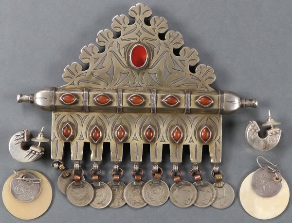 A TURKOMAN AND OTHER ETHNIC JEWELRY GROUP: A TURKOMAN AND OTHER ETHNIC JEWELRY GROUP, 1ST HALF 20TH CENTURY. Comprising a fine Turkoman silver-gilt, carnelian and chalzedon mounted tumar amulet pendant, Tekke tribe, with 9 possibly later Sovi