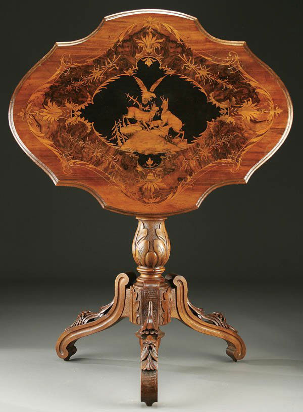 A VERY FINE SWISS "BLACK FOREST" TILT TOP TABLE,: A VERY FINE SWISS "BLACK FOREST" TILT TOP TABLE, CARVED AND MARQUETRY late 19th century oval scalloped walnut top with satin wood scrolls inlaid within a burr-walnut center. Decorated with a scene of