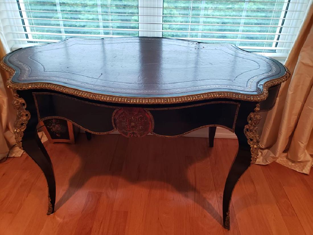 French Black and Gold Painted wood ladies desk with: French Black and Gold Painted wood ladies desk with brass detailing female relief elements on legs, brown leather top S curve leg 30H x 52L x 31D PICK UP IN PECONIC/RIVERHEAD est value $200-400