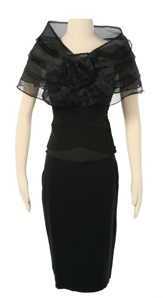 Capitol Citizen All Black Costume: Capitol Citizen All Black Costume from The Hunger Games. Black pencil skirt, black layered tube top, and custom black sheer shrug worn by actress Kawsar Alyemeni as a citizen of the Capitol. Starting 
