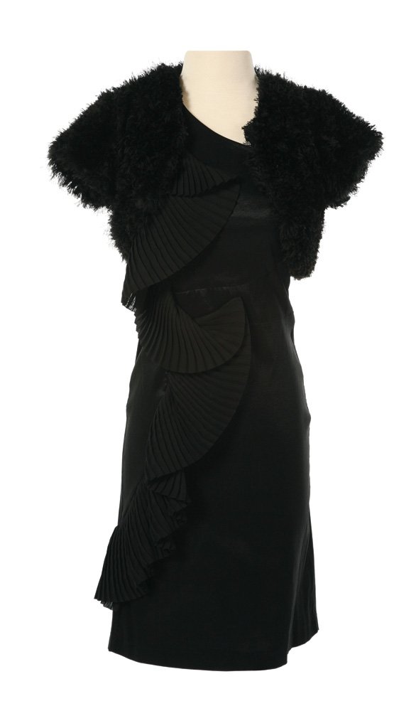 Capitol Citizen Black Dress and Shrug: Capitol Citizen Black Dress and Shrug from The Hunger Games. A black dress worn with a black fuzzy shrug by actress Amber Riddle as a citizen of the Capitol. Starting at $100