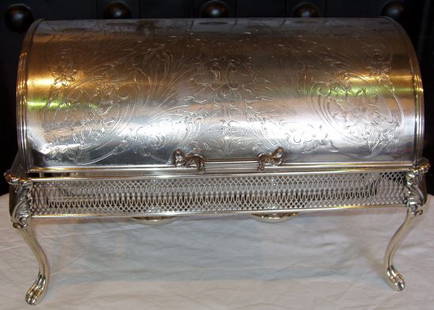 Silver Plate Casserole Server: Roll up lid. Small dent in front left corner. Smooth operating function. Beautiful engraved top. There are two burners. There are two silver plate reservoir for fluid with a piece that screws