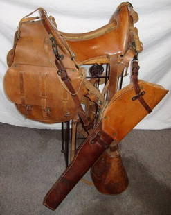 Horse Saddle, Saddle Bag, Gun Holster: We received this saddle from an estate. It looks like a cavalry style, but I'm not sure. Someone told me it could be a McCulluch Saddle. On the saddle where the horn should be, there is a brass