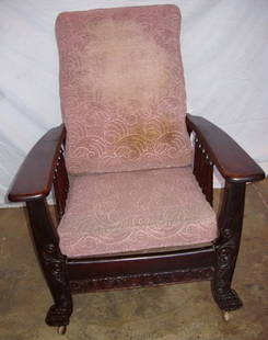 Antique Mahogany Carved Morris Chair: Antique Mahogany Heavily Carved Front Morris Chair. Original finish and back adjustment bar. One bottom slat for the back has been restored. Turn of the Century. Arms show wear on finish. 31"w