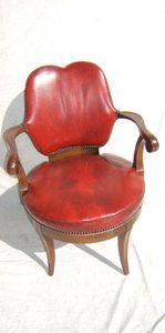 Antique Swivel Desk Chair with Leather Mahogany: The red leather shows some wear. It looks like Duncan Phyfe style. Very sturdy. Swivel 360 degrees. Very comfortable. Brass tag signed leaders Jacobus, PA Colonial Manufactured Co. Artistry Mahogany.