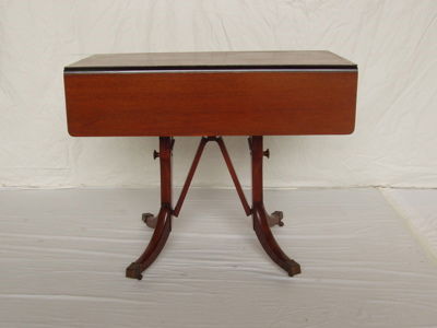 Duncan Phyfe Style Mahogany Drop Leaf Table: It could be used as a dining room table or coffee table. When the drop sides are open it measures 36"w. When its adjusted to be used as a coffee table, it measures 19 1/4"w. Approx. measurements: 21"d