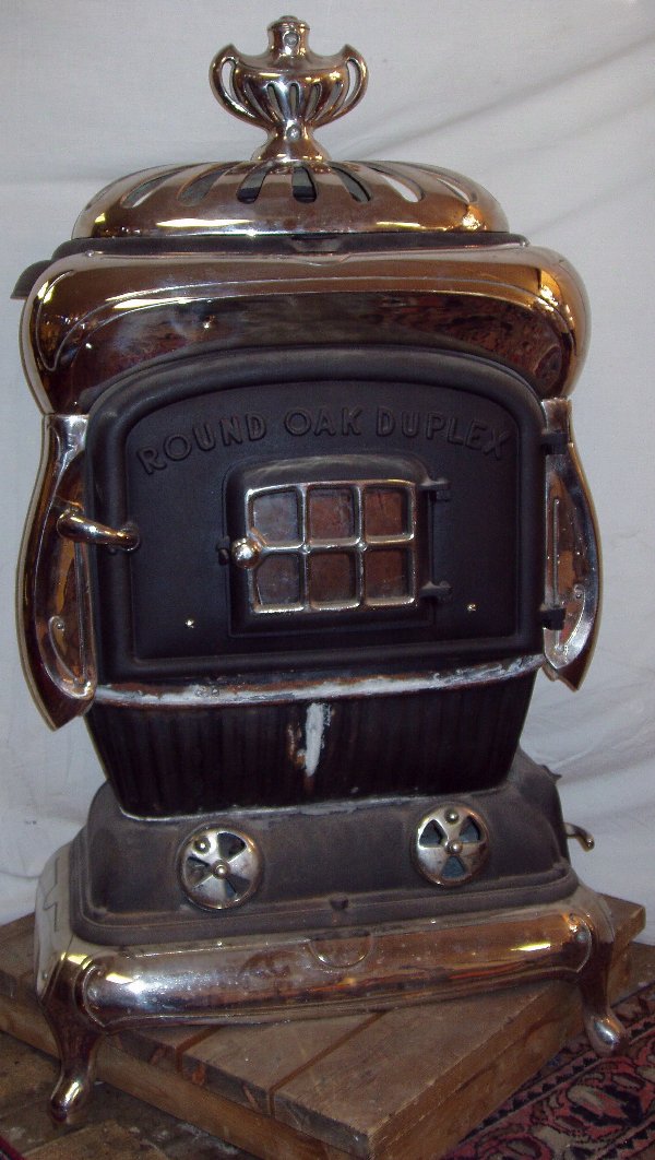 Pot Belly Stove: "Round Oak Duplex". Cast Iron with Nickel Plating. MFD by the Beckwith Co. Wagiac Michigan. 1 pieces of cast iron is missing off the bottom rim as pictured. The other curve nickel piece goes on the bo