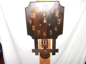 Mission Oak Wall Clock: Signed on the back with a paper label. Working condition. Approx. size is 13"w x 25 1/2"d x 5"h.