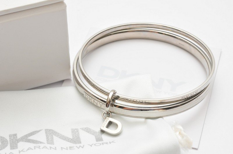 A DKNY modern designer steel bangle in original box: A DKNY modern designer steel bangle in original box