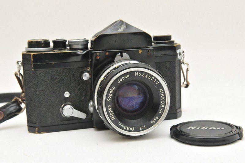A 1965 Nikon F camera Serial No. 6597810 with a 50mm Ni: A 1965 Nikon F camera Serial No. 6597810 with a 50mm Nikkor-H F50mm 1:2 lens attached