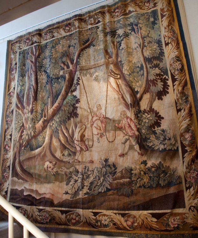 Aubusson Pictorial Tapestry: 19th century, France Reproduction of a 17th century Aubusson tapestry, signed and dated 1739. French pastoral genre scene with a young woman poised on a swing accompanied by two “Gallants”. Very g
