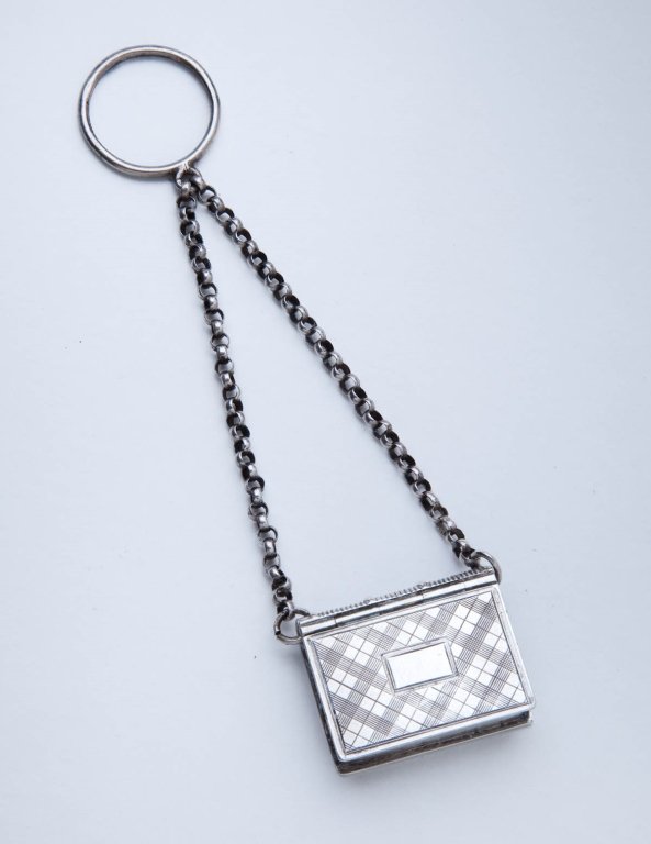 Sterling Silver Book Form Vinaigrette: 1830, Birmingham, England Suspended on chain, with pierced interior by John Taylor & John Perry. Excellent condition. height 1in; width 3/4in (length 4in suspended on chain)