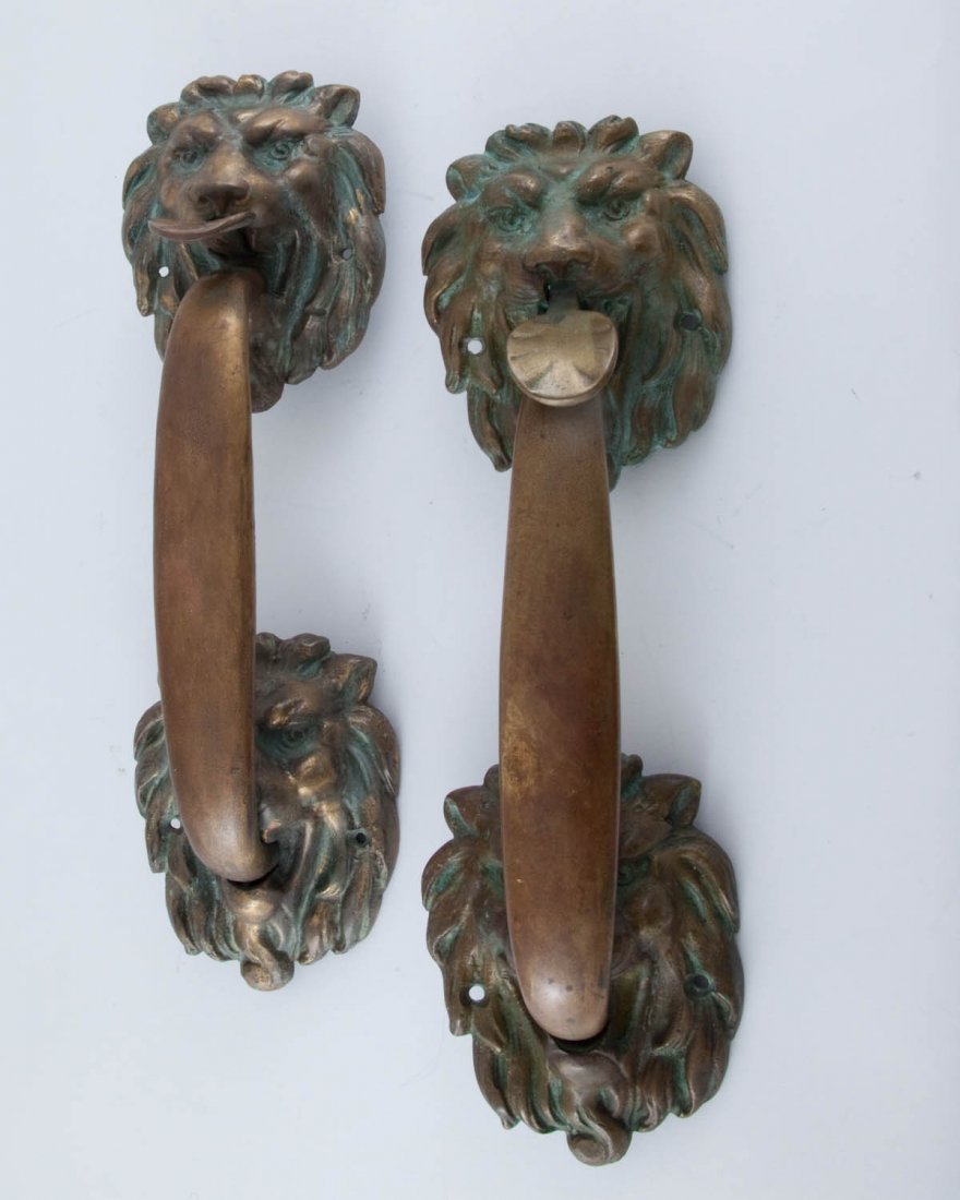 Pair Bronze Lion Head Door Pulls: circa 1902-1930. Verde and patenated bronze height 14in; width 4.75in