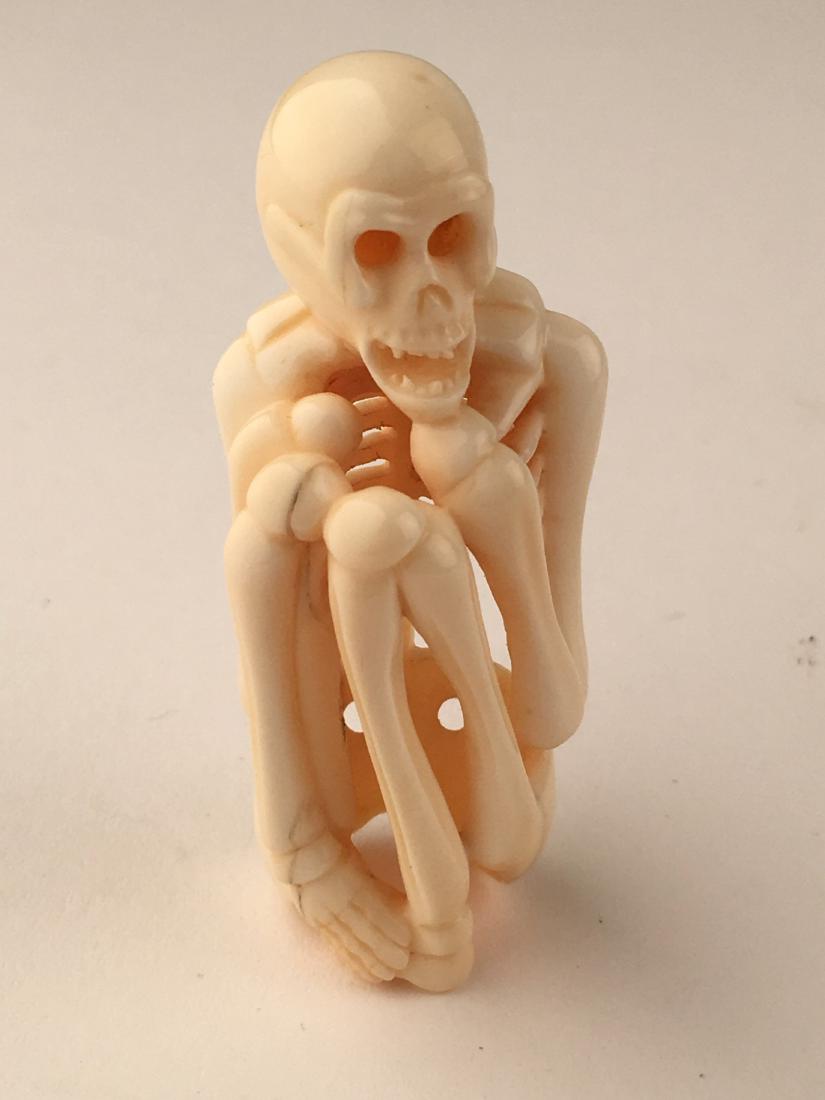 A carved netsuke figure of a skelton. Signed. Height 2m (1 of 5)