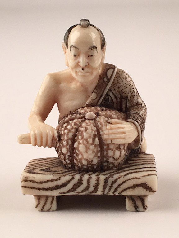 Carved netsuke figure of a man cutting a melon (1 of 5)