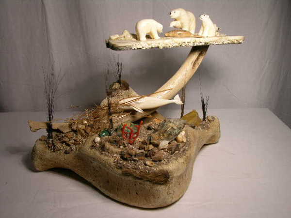 "ALASKAN WALRUS IVORY POLAR BEAR DIORAMA. USE OF: "ALASKAN WALRUS IVORY POLAR BEAR DIORAMA. USE OF MANY NATURAL MATERIALS. SCENES DEPICTING THREE POLAR BEARS, ONE WALRUS, ONE BIRD AND A WHALE. OVERALL HEIGHT 10 1/2."