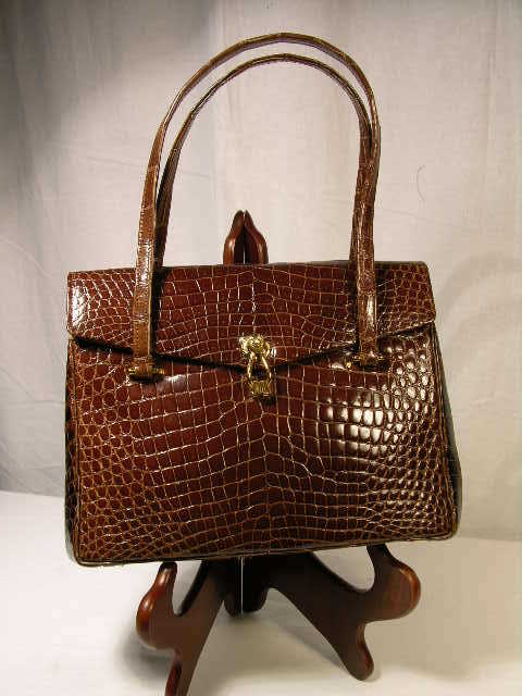 MORABITO BROWN ALLIGATOR HANDBAG. THIS IS THE FI: MORABITO BROWN ALLIGATOR HANDBAG. THIS IS THE FINE WORK OF THE MORABITO COMPANY OF PLACE VENDOME, PARIS. THE WORKMANSHIP IS OUTSTANDING AS WELL AS THE SOFT AND SUPPLE DOESKIN INTERIOR LINING. THE COLO