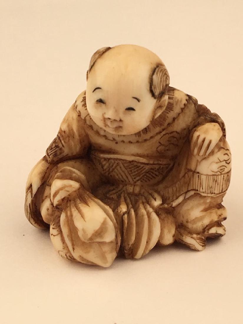 Antique carved Netsuke figure of a sitting person with (1 of 6)