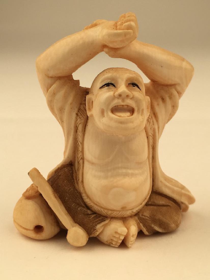 Antique carved Netsuke figure of a man sitting with his (1 of 5)