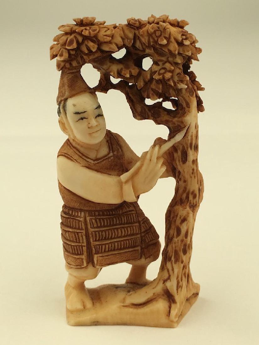 Antique carved Netsuke figure of a man under a lotus (1 of 5)