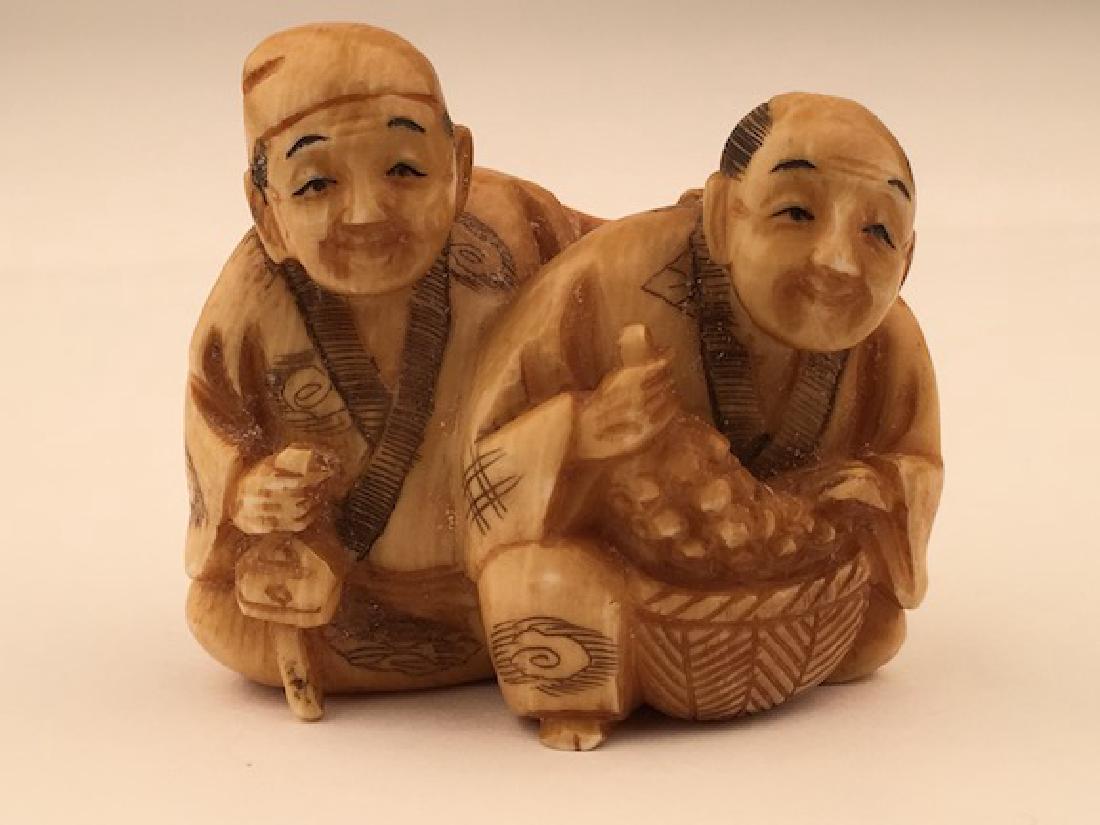 Antique carved Netsuke figure of a man and lady with a (1 of 5)