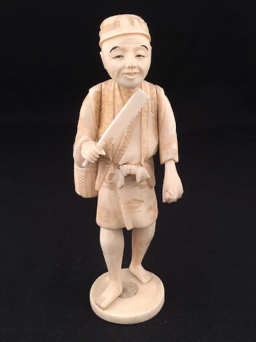 A carved kimono of a man with a saw. (1 of 9)