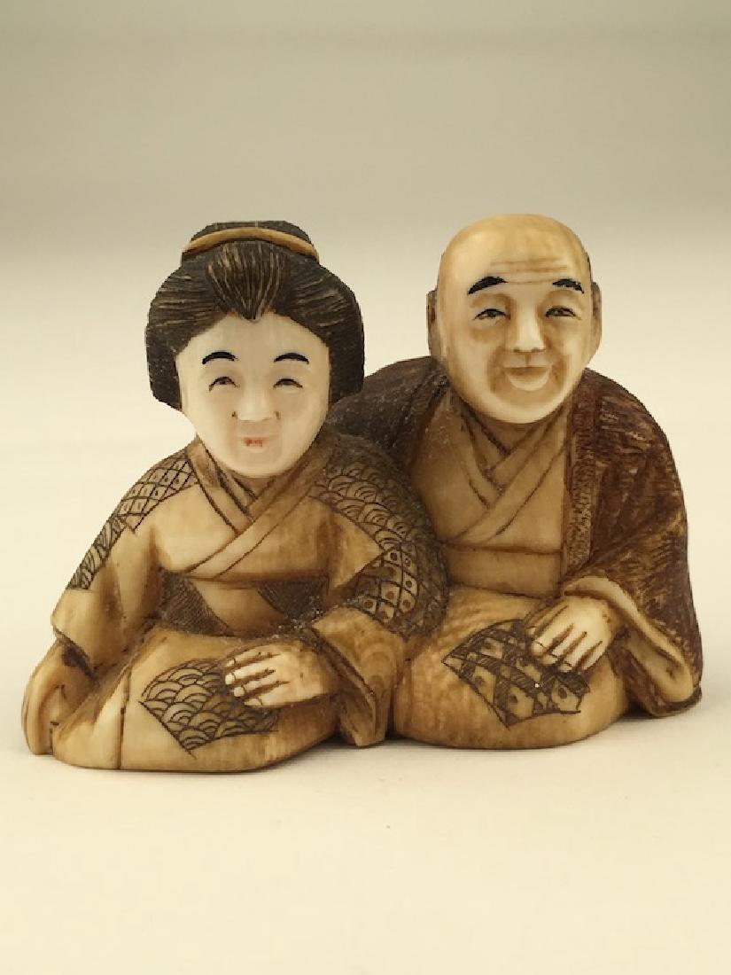 Antique carved Netsuke figure of a man and lady sitting (1 of 5)