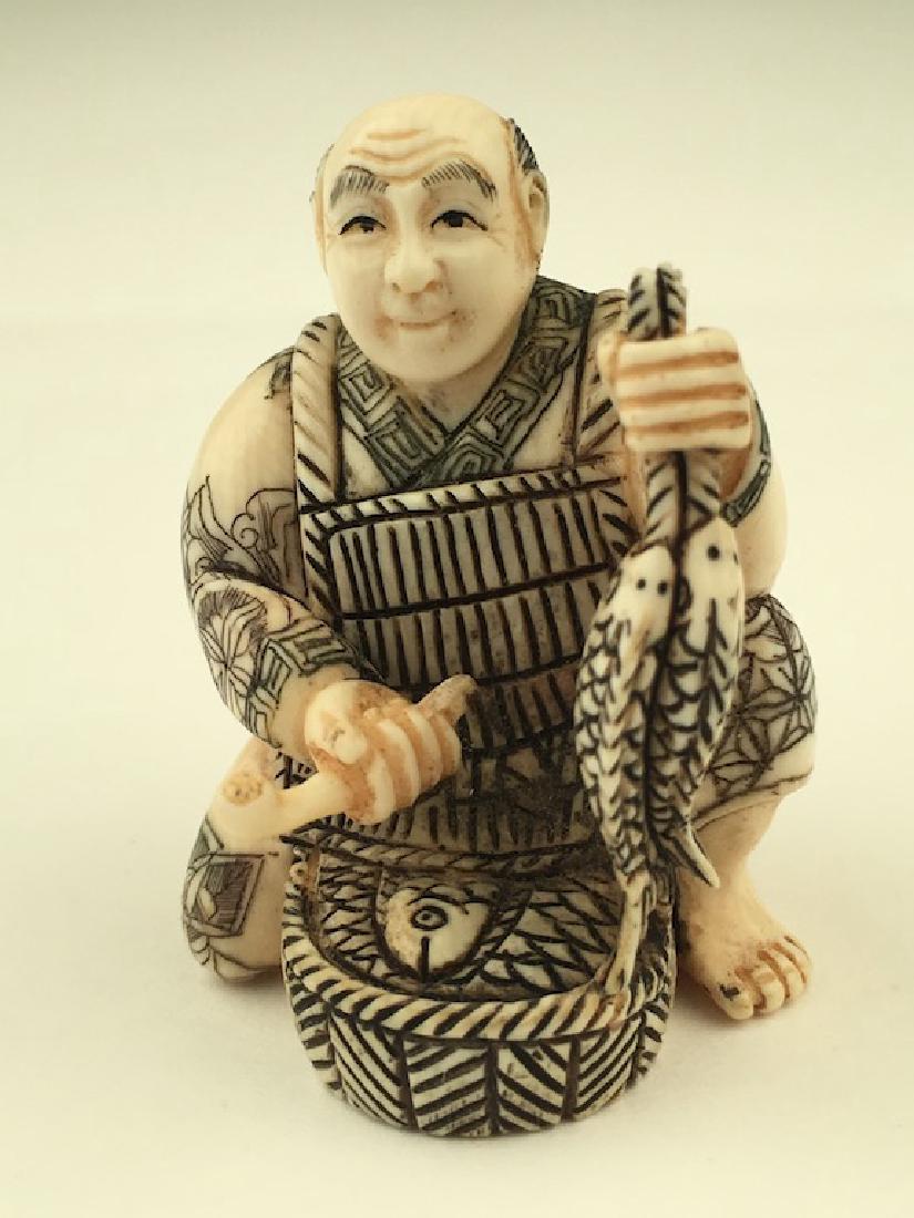 Antique carved Netsuke figure of a man with a basket of (1 of 5)