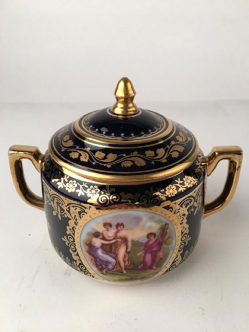Royal Vienna covered sugar. Decorated with two: Royal Vienna covered sugar. Decorated with two cartoches of a romantic scene. Height 3 3/4 inches.