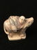 Carved Netsuke figure of a man on the back of a boar.