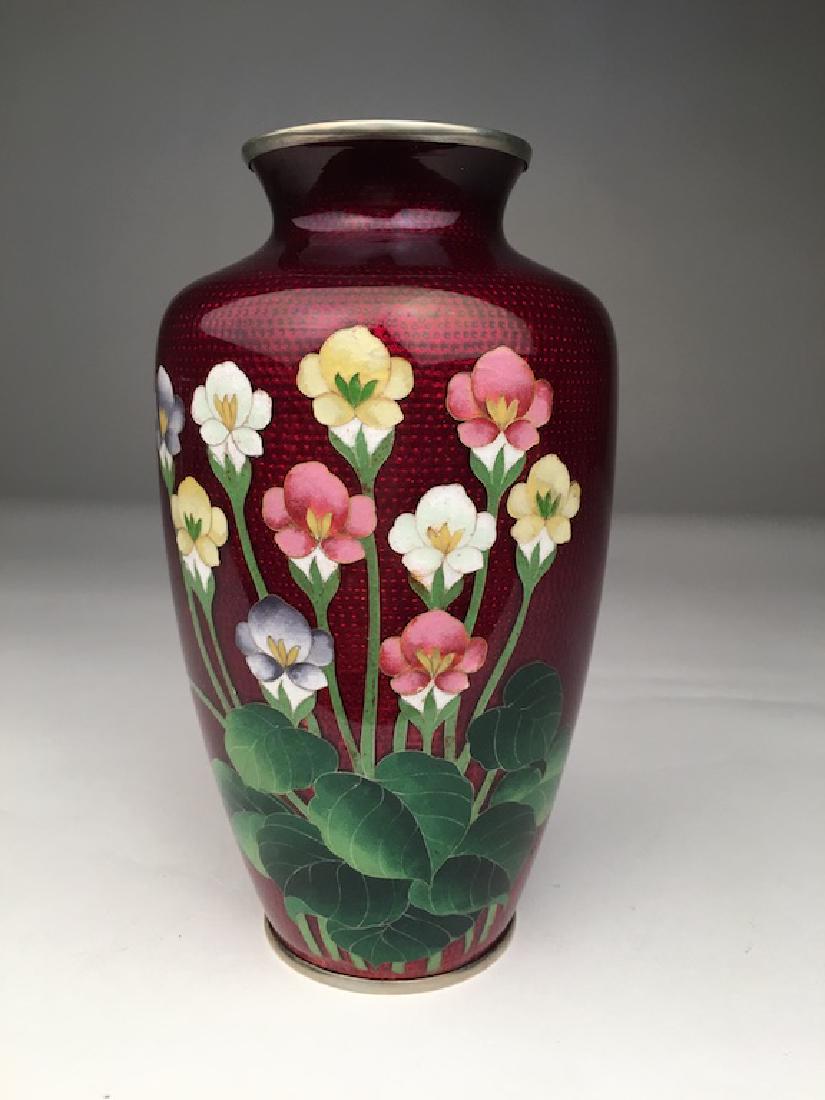 Circa 1900 Japanese cloisonne metalware vase: Circa 1900 Japanese cloisonne metalware vase with flowers on an ox red ground. Height 7 1/4 inches. Mouth opening 2 1/8 inches.