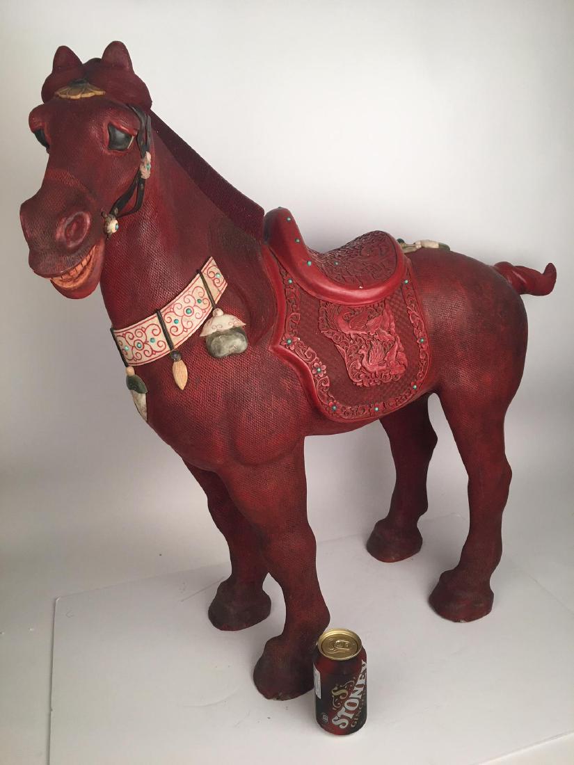 A large late 20 th century cinnabar horse: A late 20 th century cinnabar lacquer horse.Carved saddle with semi precious stone inserts.Signed underneath the horses belly.Height 31 inches. (Normal wear conditions for this aged item, please see a