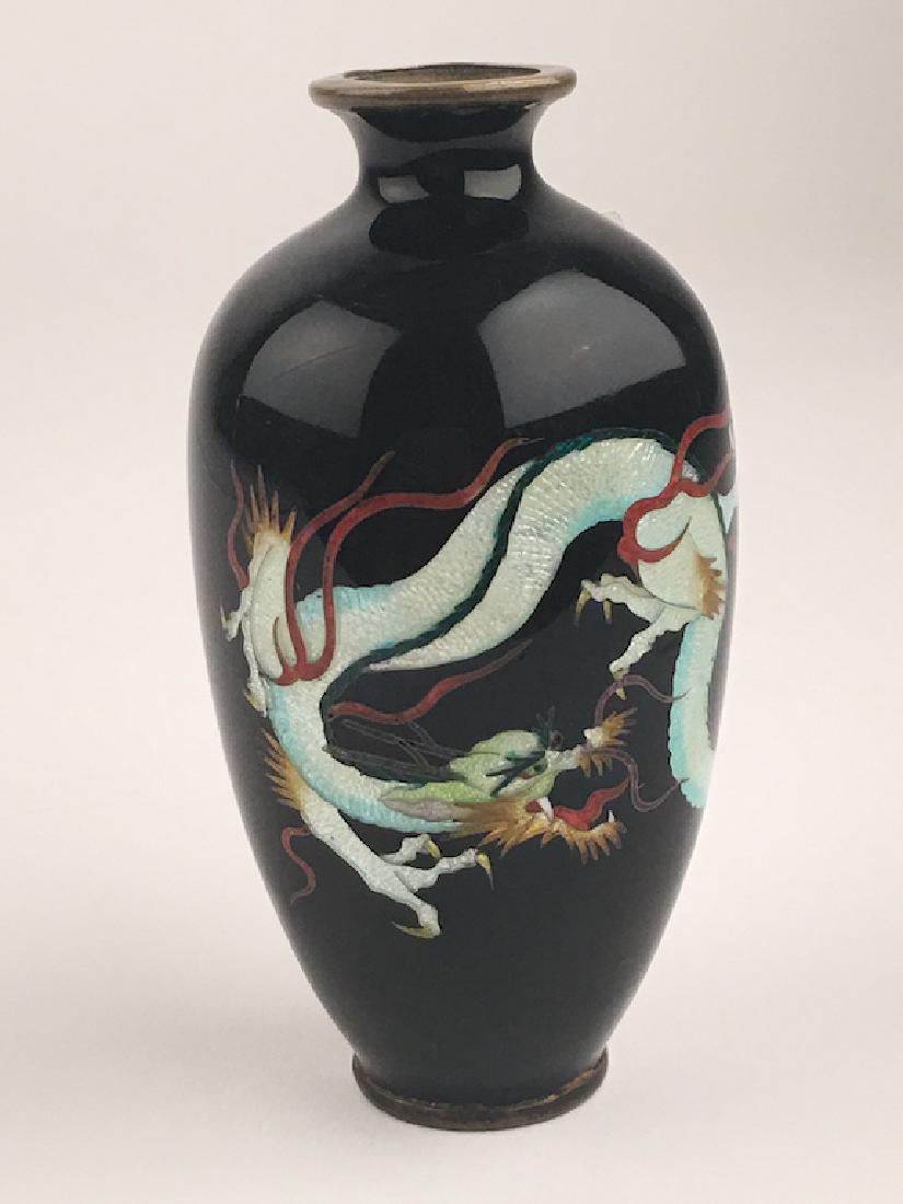 Japanese Meiji period enamel vase.Decorated with a: Japanese Meiji period enamel vase. Decorated with a large dragon on a plum ground. Signed on the bottom. Height 4 inches. 6981 $ 200.00