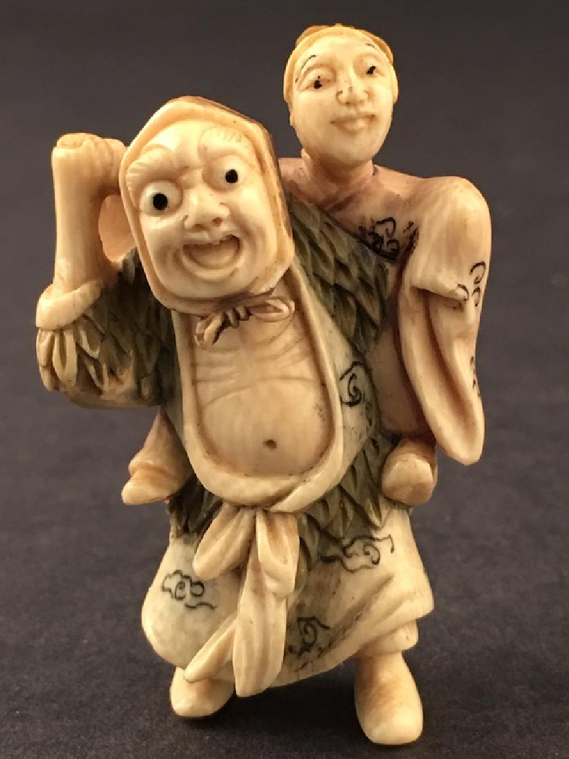 A carved Netsuke figure. Signed. Height 2 inches. (1 of 6)