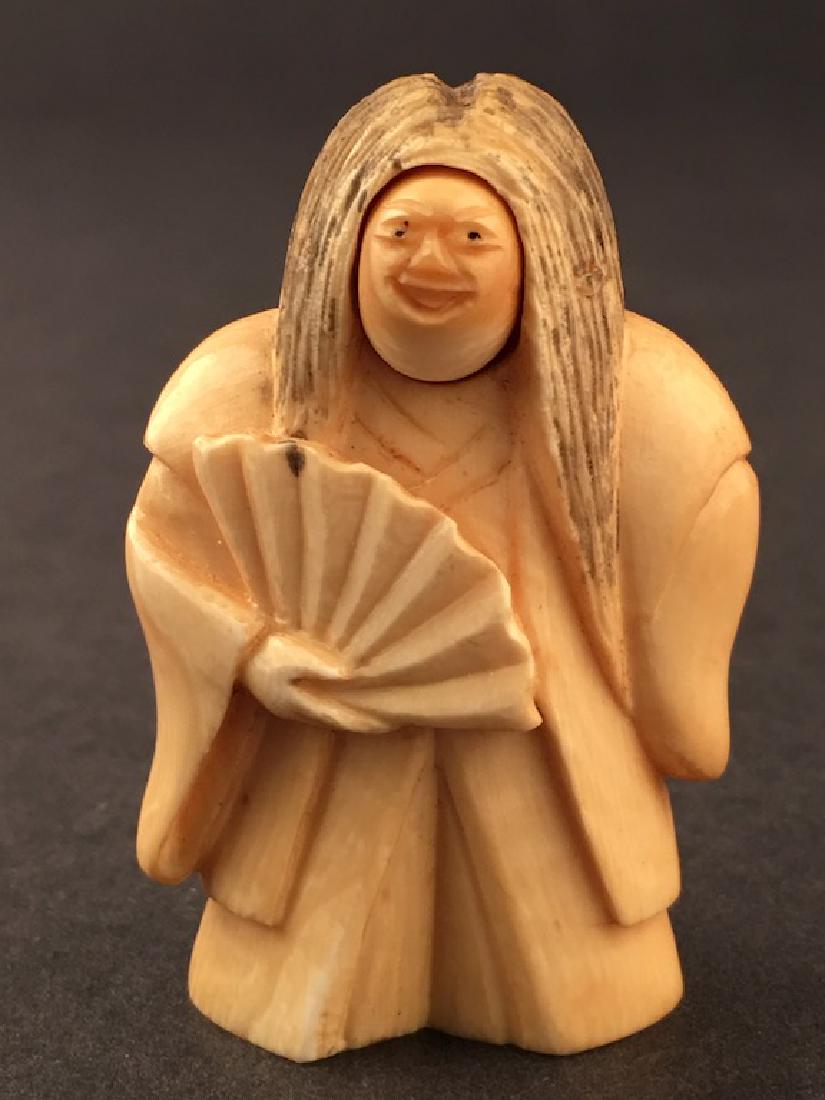 Carved Netsuke figure of a woman holding a fan. The (1 of 7)